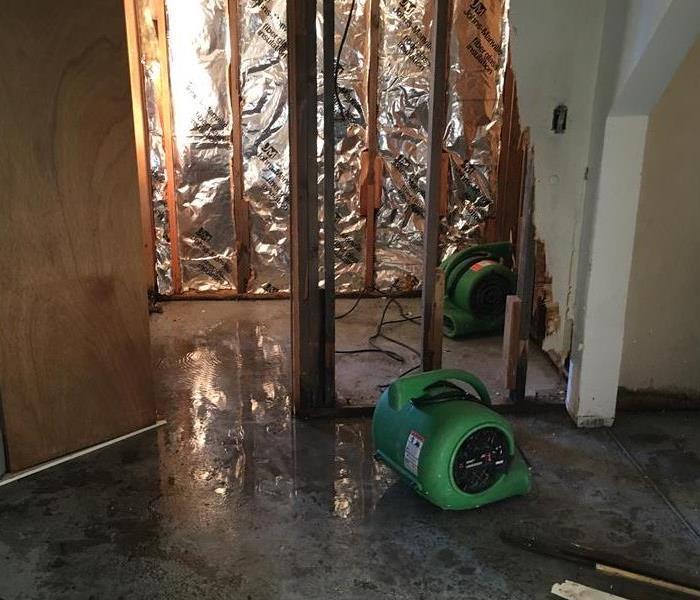 water damaged house with dehumidifiers set out