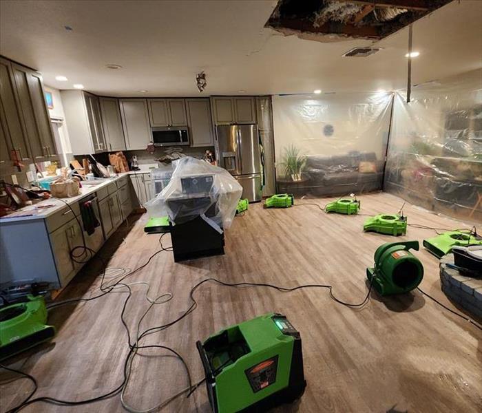 Air Movers drying out a kitchen that has been damaged by water