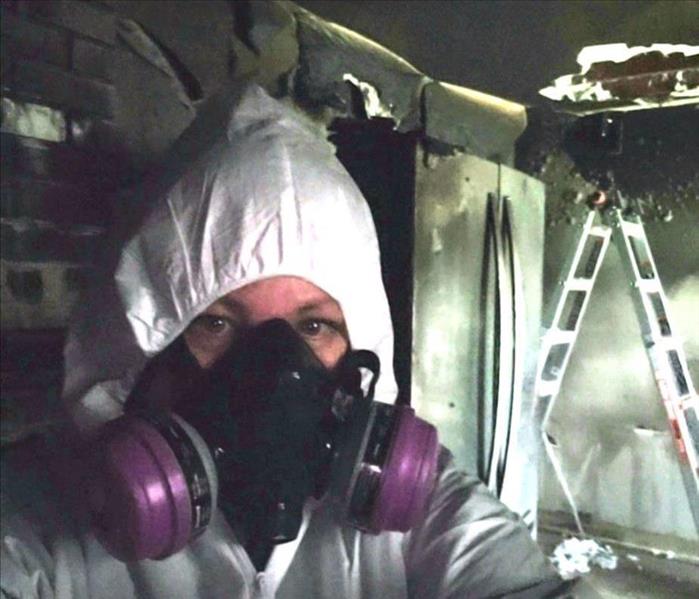 One of our techicians working on a fire job in a full mask and tyvek suit